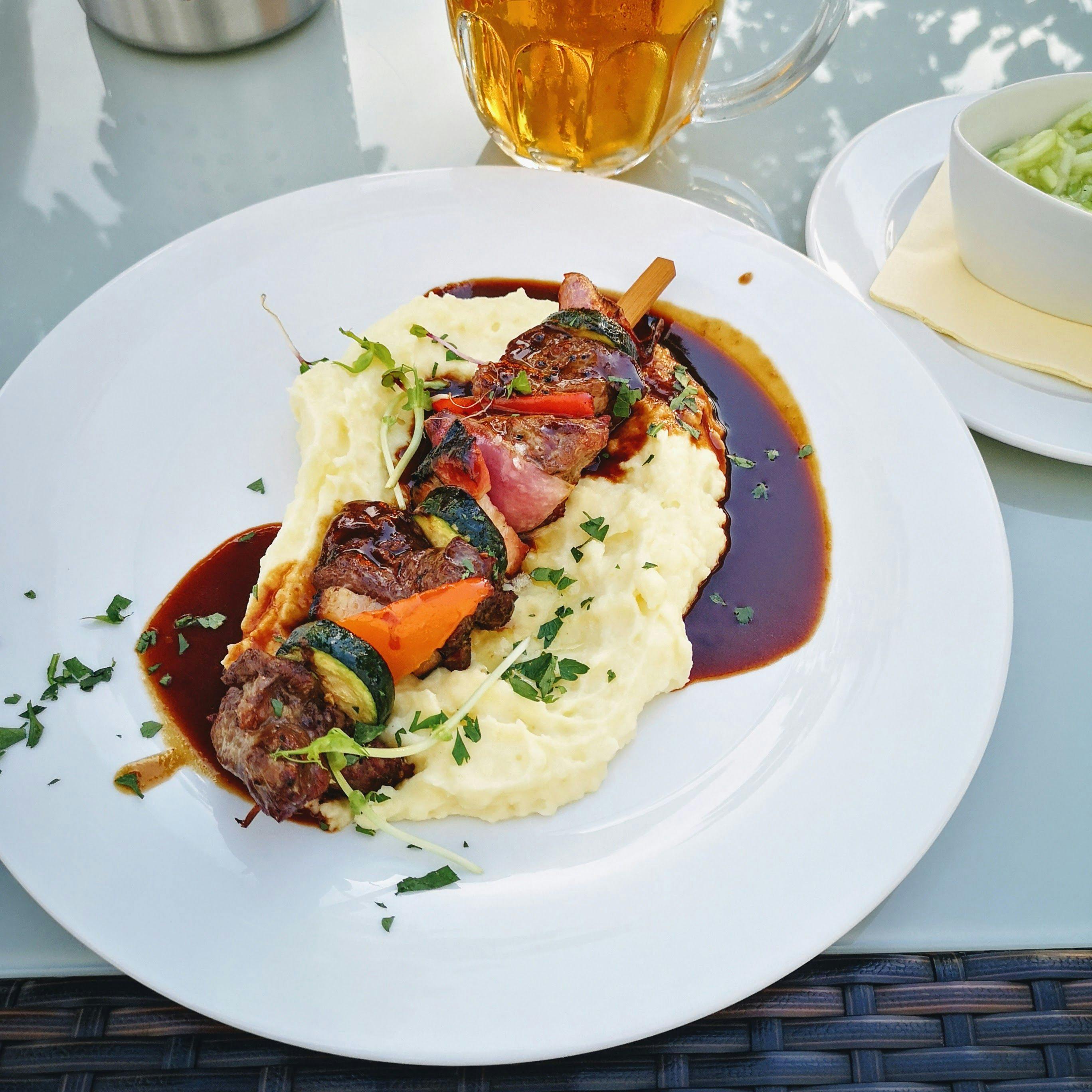 plate of mash potato and a meat skewer